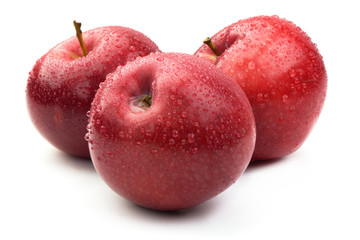 Red ripe apples with drops, isolated on white background. Fresh raw organic fruits.