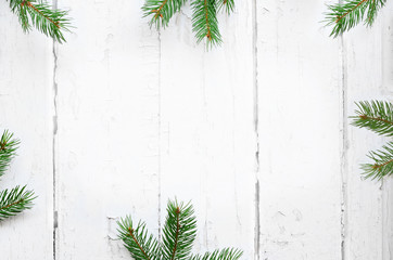 Fir branch on old wooden shabby background with copy space for text. Christmas.