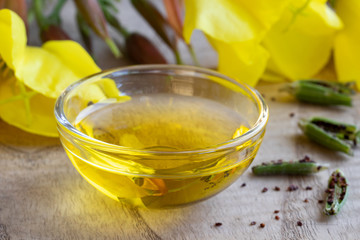 Evening primrose oil with evening primrose flowers and seeds