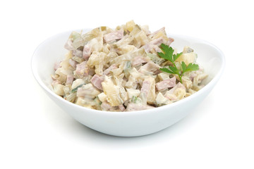 Russian traditional salad Olivier with vegetables and meat. Winter salad.