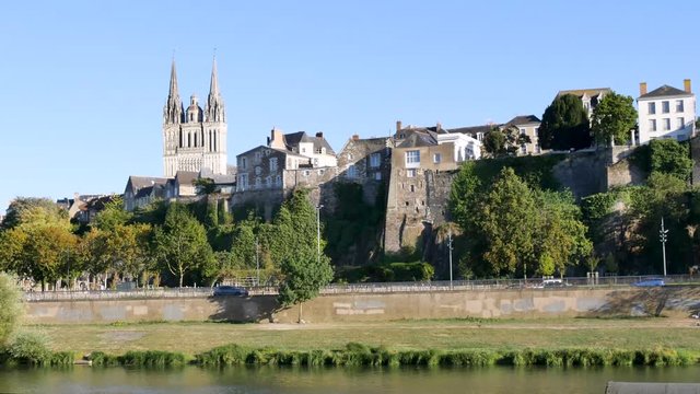 The Maine is a French river in the department of Maine-et-Loire that flows through the city of Angers in France. View of the river banks (city centre). In the background there is the Angers Cathedral.