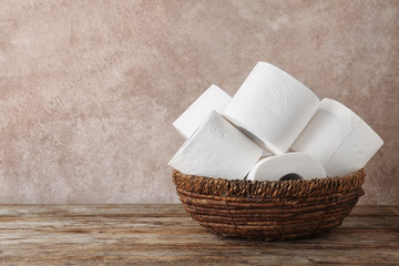 Bowl with toilet paper rolls on wooden table. Space for text - obrazy, fototapety, plakaty