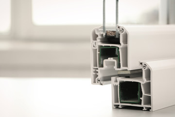 Sample of modern window profile on table, closeup. Space for text