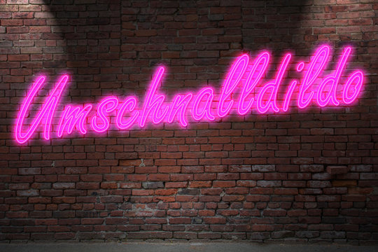 Leuchtreklame Umschnalldildo an Ziegelsteinmauer