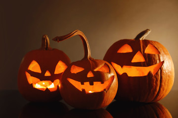 Halloween pumpkin heads. Glowing jack lanterns on dark background