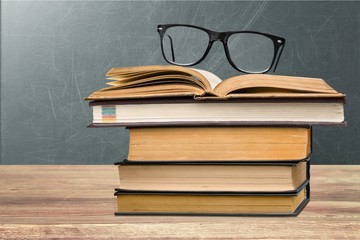 Collection of old books and glasses on