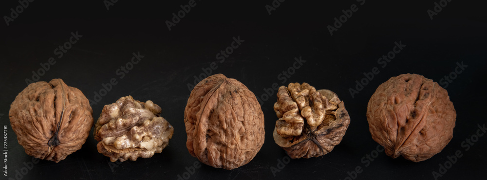 Wall mural large walnuts on black background - Wall murals