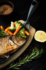 Baked fish with vegetables and lemon