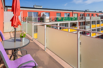 Sunny balcony exterior with chairs