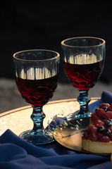 Two glasses of wine and cakes.
