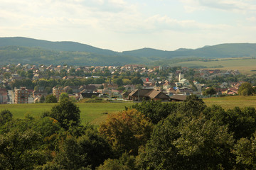 View of a little town with low mountains in the background