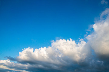 Blue sky cloudscape and white clouds background with sunbreams