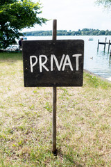 Black sign PRIVAT. View of an Old Weathered 'Private' Sign. Vertical
