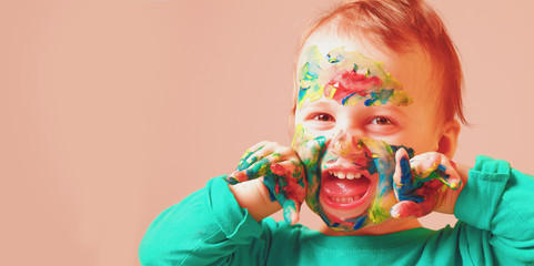 Children's makeup. Funny little cute child girl with a painted face (humorous picture)