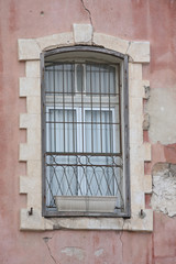 old window with bars, cracked wall background