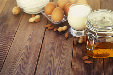 Healthy food. Almond milk with honey, fresh eggs on wooden background. Wooden table. Copy space.