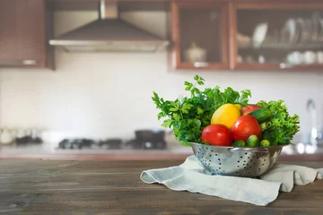 Papier Peint photo Légumes Modern kitchen with fresh vegetables on wooden tabletop, space for you and display products.