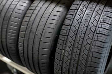 New Compact Vehicles Tires Stack. Winter and Summer Season Tires.Car tires isolated.repair garage. replacement of winter and summer tires.