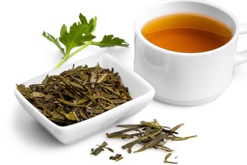 Cup of Green Tea with Dried Leaves Tea in Bowl
