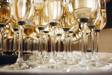 Champagne glasses on gold background. Party and holiday celebration concept.