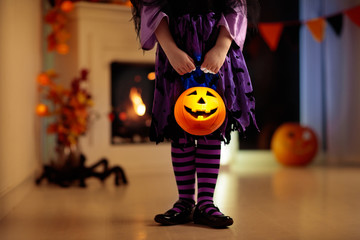 Kids in witch costume on Halloween trick or treat