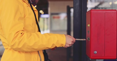 Woman Uses Train Ticket in Ticket Checking Machine on a Station. SLOW MOTION 4K. Unrecogbizable Girl uses smart city technology to get admission to train, bus or subway station. 