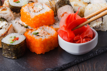 Womens hand holding wooden sticks Philadelphia and california roll