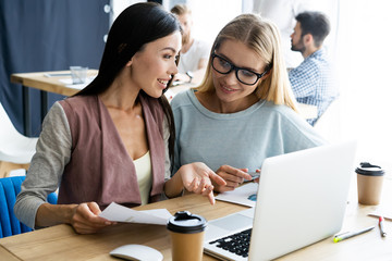 Fototapeta premium Two female colleagues in office working together.