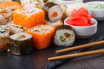 Sushi Roll with salmon, eel, tuna, avocado, cream cheese Philadelphia, caviar tobica, chuka. Sushi menu. Japanese food on table