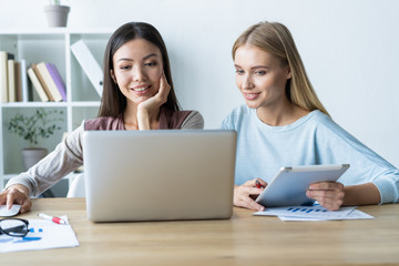 Two female colleagues in office working together.