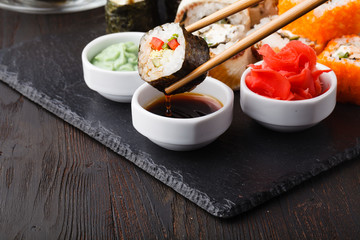 Various kinds of sushi food served on black stone