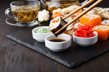 Served sets of sushi rolls with fish, rice,cream cheese and vegetables