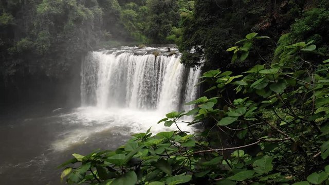 4k cinematic revealing pan of the powerful Tad Champee waterfall in the Bolaven plateau in Laos, Southeast Asia.