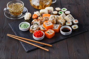 Fototapeta na wymiar Japan rolls with fish and rice, pile asorted on table