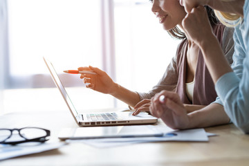 Two female colleagues in office working together.