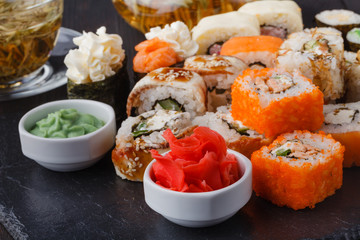 Served sets of sushi rolls with fish, rice,cream cheese and vegetables