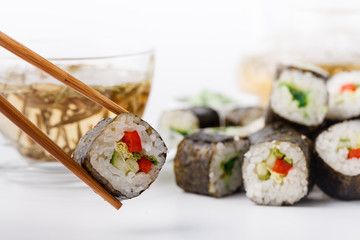 Womens hand holding wooden sticks Philadelphia and california roll