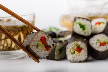 Fresh and delicious maki and nigiri sushi rolls and green tea glass