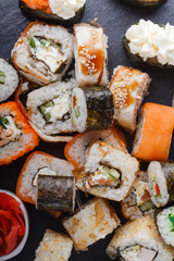 Various kinds of sushi food served on black stone