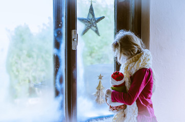 winter christmas concept and girl by the window