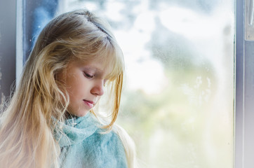 sad girl by window