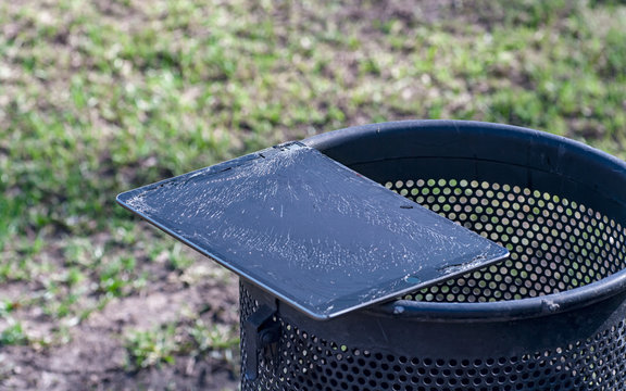 Modern tablet with highly broken screen lies on the trash.