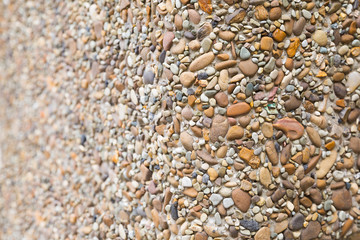 Texture of small white cobble stone. Sunlight blick. Part sharp and fuzzy. Copyspace, place for text