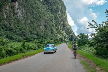 Girl  riding on the bike in Viniales, Cuba