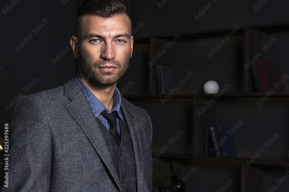 Wall mural portrait of a handsome stylish man in a suit. business man with a confident look