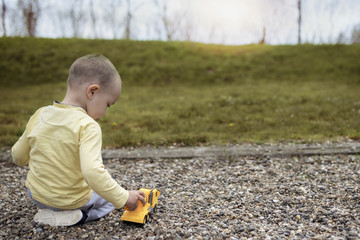 Adorable little boy having fun on playground. Child is playing in nature.