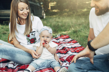 Outdoor Shot of Young Couple with Their Daughter in Love