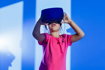 Virtual experiment. Smart cute happy girl touching VR glasses which she wearing when smiling