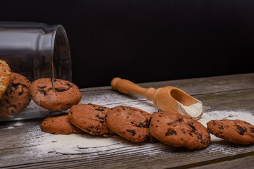 Oatmeal cookies with honey and chocolate cookies on brown wooden table. Food, holiday, cooking, baking background. Concept of home and healthy eating.