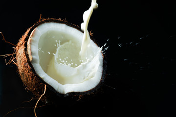 coconut and juice on black background
